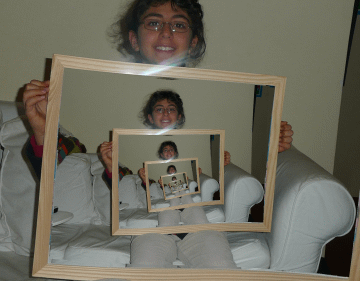 The same photograph, but the nested copies rotate as they shrink, winding the whole image into a smooth spiral.